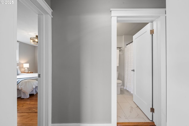 hallway featuring marble finish floor