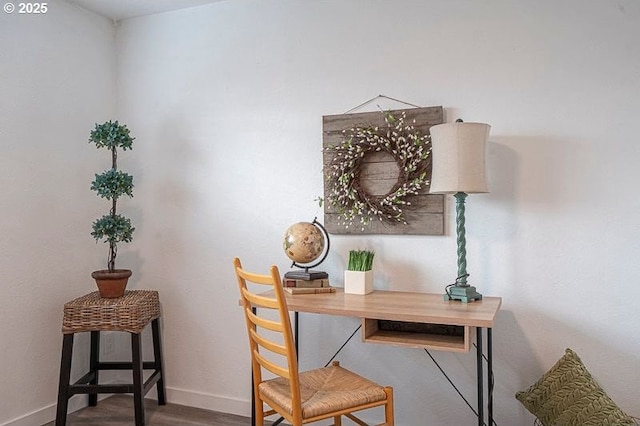 home office with baseboards and wood finished floors