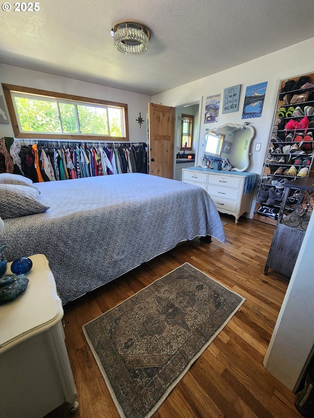 bedroom with dark wood-style floors