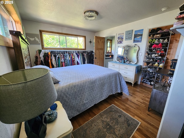 bedroom with wood finished floors and a textured ceiling