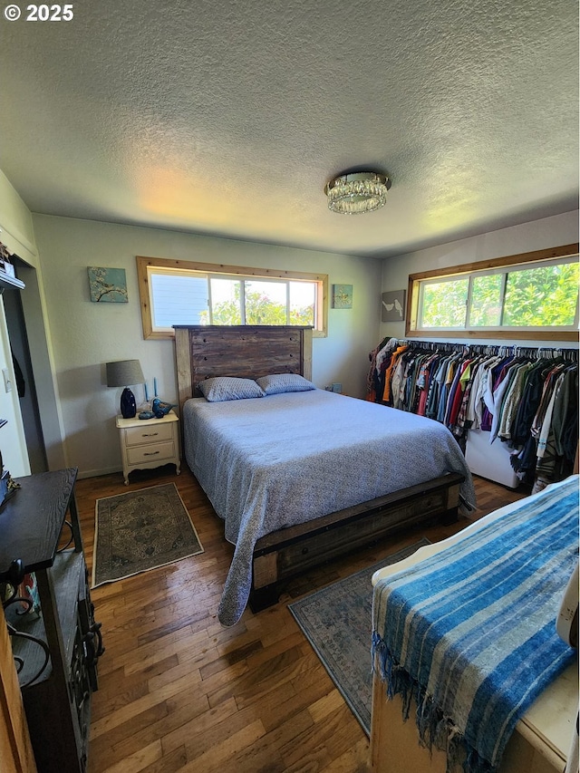 bedroom with wood finished floors and a textured ceiling