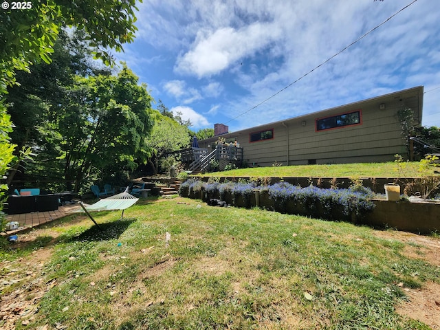 view of grassy yard featuring stairway
