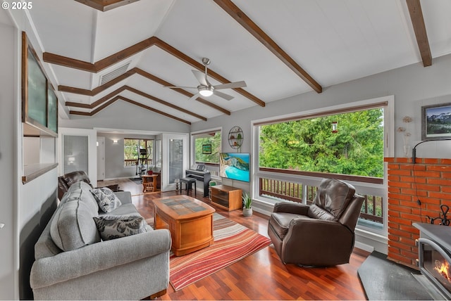 living room featuring visible vents, wood finished floors, and vaulted ceiling with beams