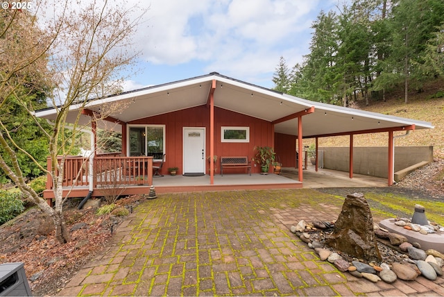 back of house with an attached carport and board and batten siding