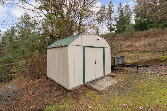 view of shed with fence