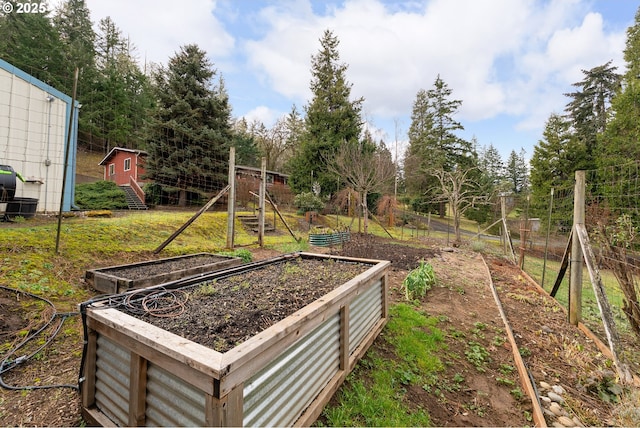 view of yard featuring fence and a garden