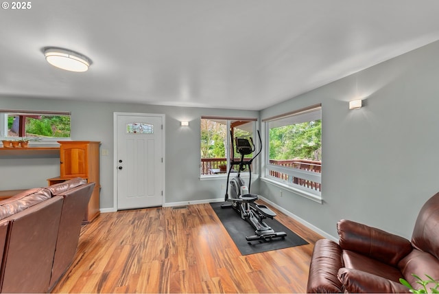 workout room with wood finished floors and baseboards