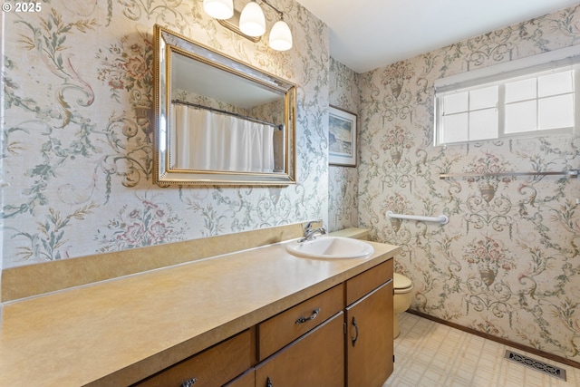 bathroom featuring vanity and toilet