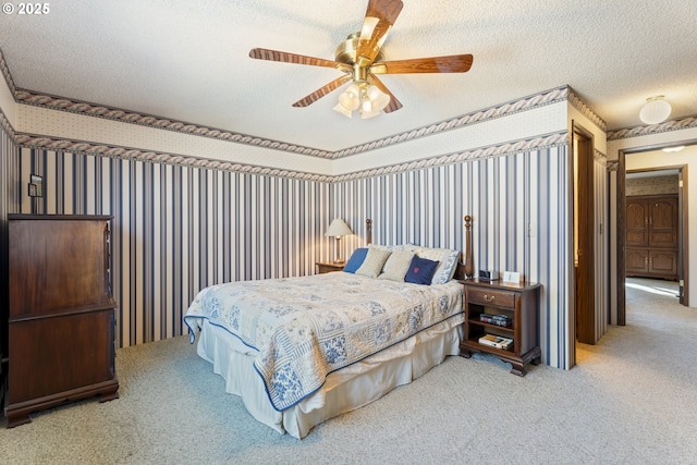 carpeted bedroom featuring ceiling fan and a textured ceiling