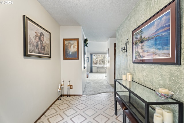 hall with a textured ceiling