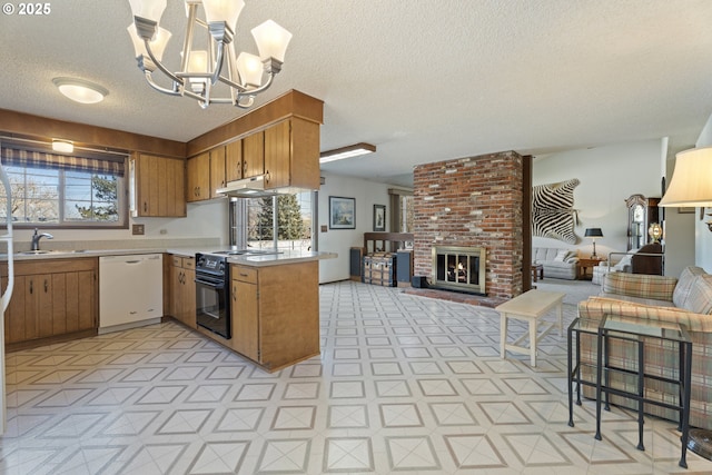 kitchen with decorative light fixtures, white dishwasher, kitchen peninsula, black range with electric stovetop, and a brick fireplace