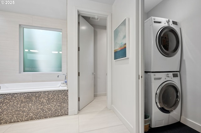 3701 SW 38th Ave, Portland, OR 97221 - laundry area featuring stacked washer / dryer and tile patterned flooring