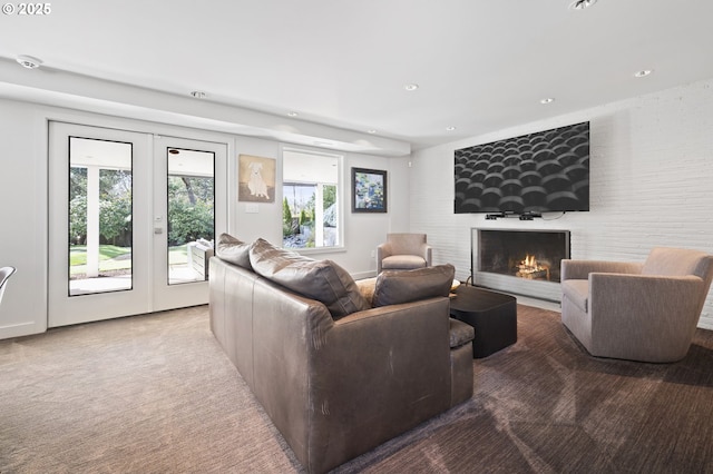3701 SW 38th Ave, Portland, OR 97221 - carpeted living room featuring french doors, a fireplace, and recessed lighting