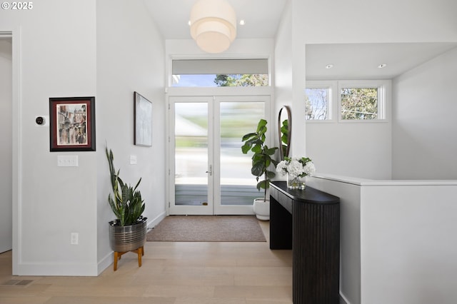 3701 SW 38th Ave, Portland, OR 97221 - foyer with healthy amount of natural light, wood finished floors, french doors, and recessed lighting