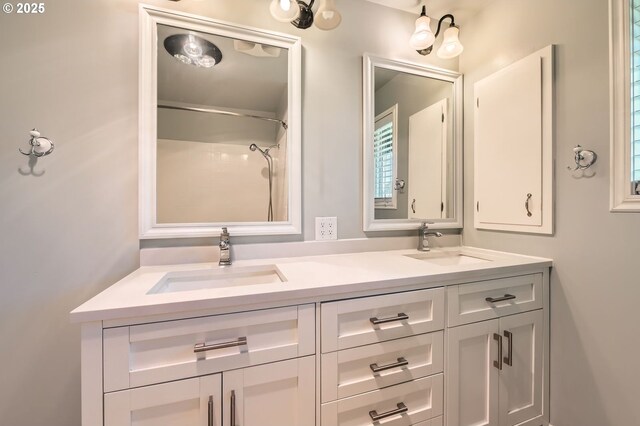 full bath with double vanity and a sink