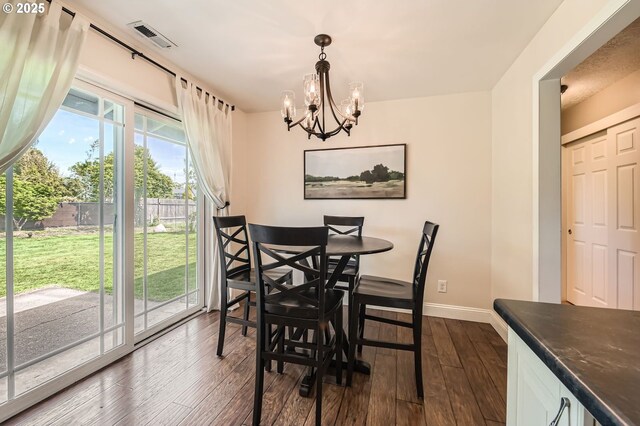 dining room with an inviting chandelier, baseboards, dark wood-style flooring, and visible vents