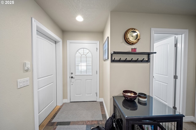 29027 Vizcaino Ct, Gold Beach, OR 97444 - doorway featuring baseboards and a textured ceiling