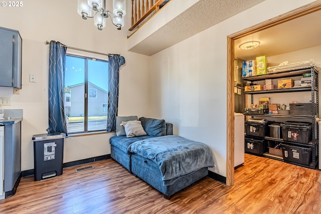 bedroom featuring hardwood / wood-style flooring and an inviting chandelier