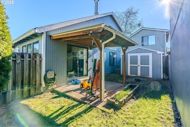 back of property with a patio, a shed, and a lawn