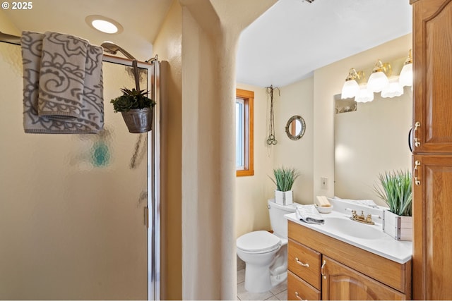 bathroom with vanity, toilet, tile patterned floors, and a shower with shower door