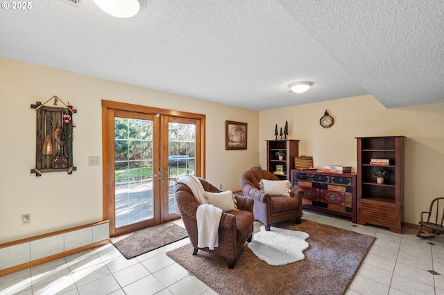 living room with light tile patterned flooring, a textured ceiling, and french doors