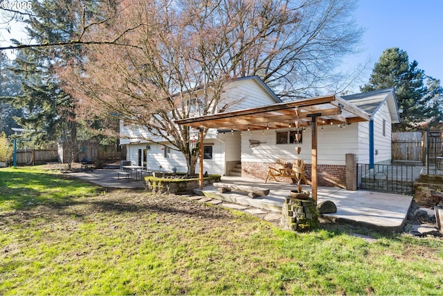 rear view of property with a yard and a patio area