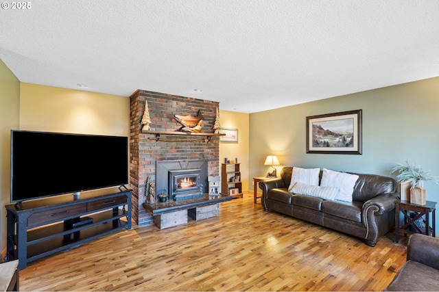 living room with a textured ceiling and light wood-type flooring