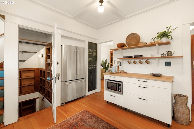 kitchen featuring appliances with stainless steel finishes, white cabinets, open shelves, and light wood-type flooring