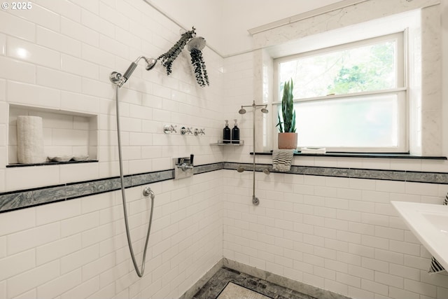 bathroom with tile walls and a tile shower