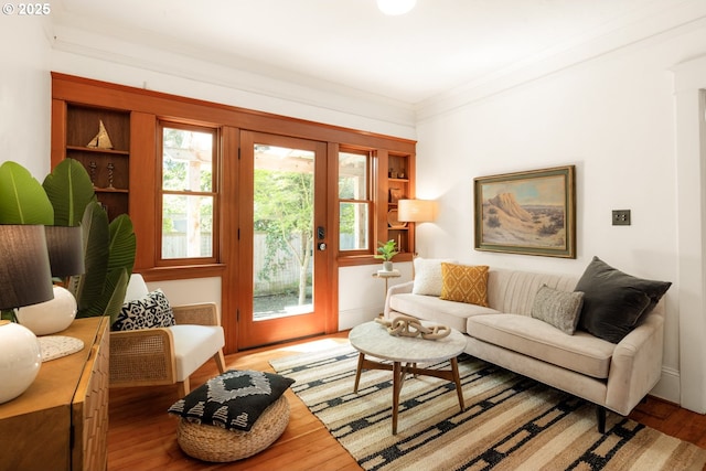 living room featuring crown molding and wood finished floors