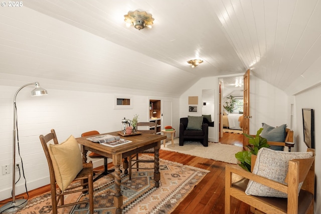 dining space featuring lofted ceiling and hardwood / wood-style floors
