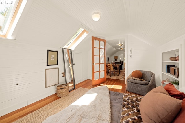 interior space featuring wood ceiling, lofted ceiling with skylight, and wood finished floors