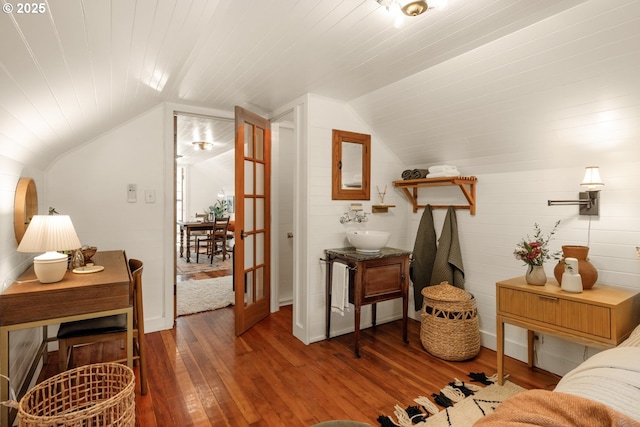 interior space featuring wood-type flooring and lofted ceiling