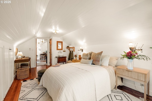 bedroom with wood ceiling, wood finished floors, and vaulted ceiling