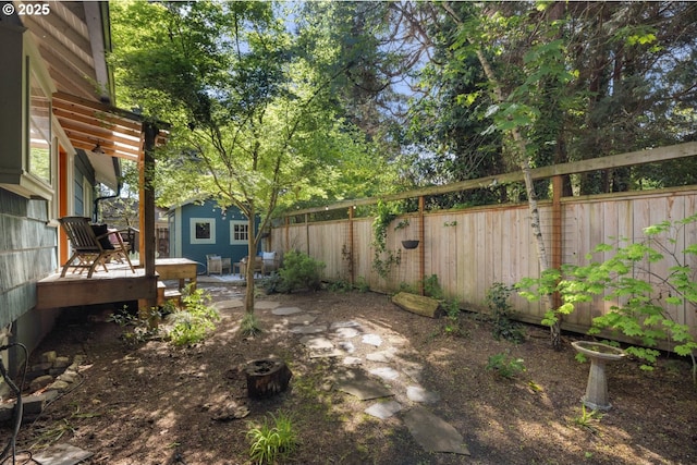 view of yard featuring a fenced backyard, an outdoor structure, and a deck