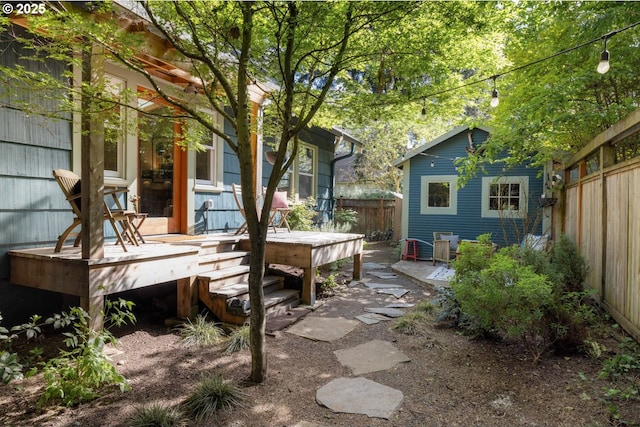 view of yard featuring fence and a wooden deck