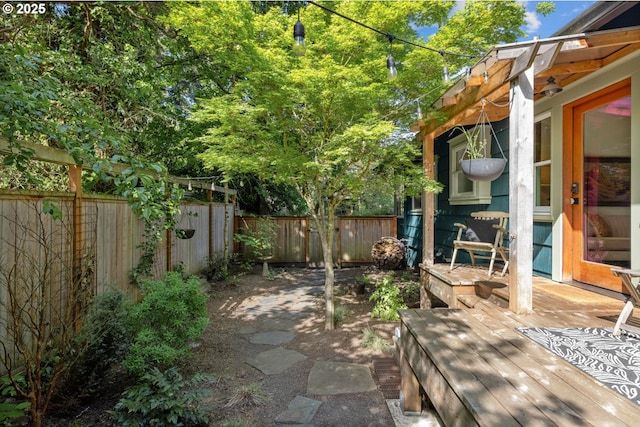 view of patio with a fenced backyard and a deck