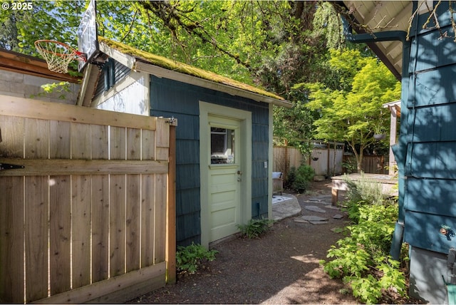 view of shed featuring fence