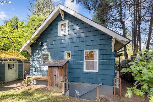 back of property featuring an outbuilding and a shed