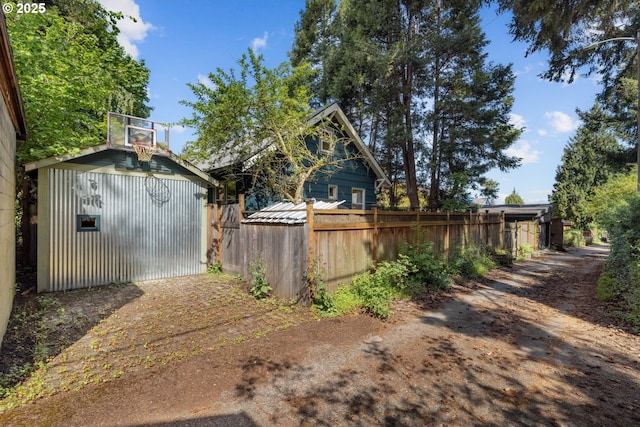view of yard with fence and an outbuilding