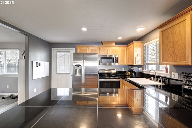 kitchen featuring stainless steel appliances, dark countertops, recessed lighting, a sink, and baseboards