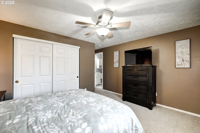 bedroom featuring a textured ceiling, a ceiling fan, baseboards, a closet, and carpet