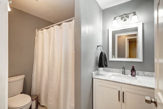 bathroom featuring toilet, a shower with curtain, and vanity