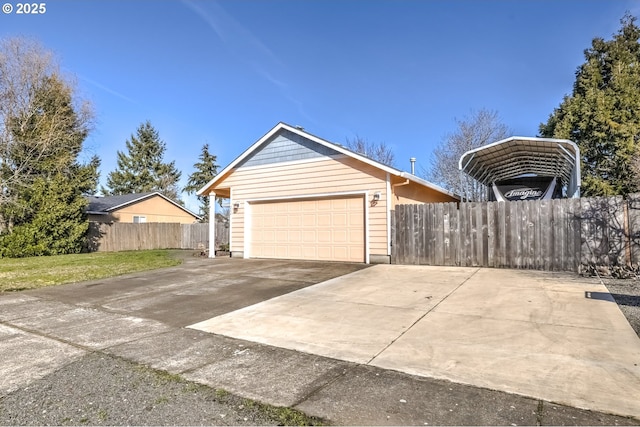 view of front of house featuring a garage, concrete driveway, and fence