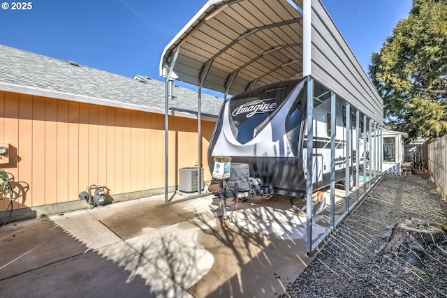 exterior space featuring fence and a detached carport