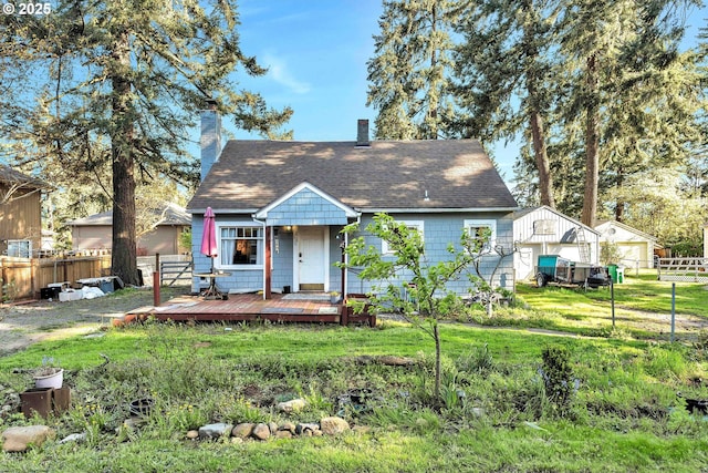 12107 SE Carlton St, Portland, OR 97266 - view of front of property featuring a chimney, a wooden deck, fence, and a front lawn