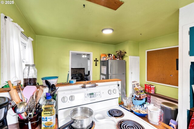 12107 SE Carlton St, Portland, OR 97266 - kitchen with a wood stove, electric stove, and freestanding refrigerator