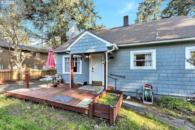 12107 SE Carlton St, Portland, OR 97266 - back of house with a chimney, fence, a deck, and a shingled roof