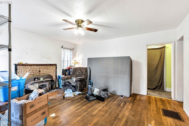 12107 SE Carlton St, Portland, OR 97266 - interior space featuring wood-type flooring, a wood stove, visible vents, and a ceiling fan