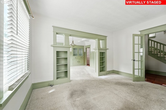 4529 SE 44th Ave, Portland, OR 97206 - carpeted spare room featuring french doors, a chandelier, and plenty of natural light